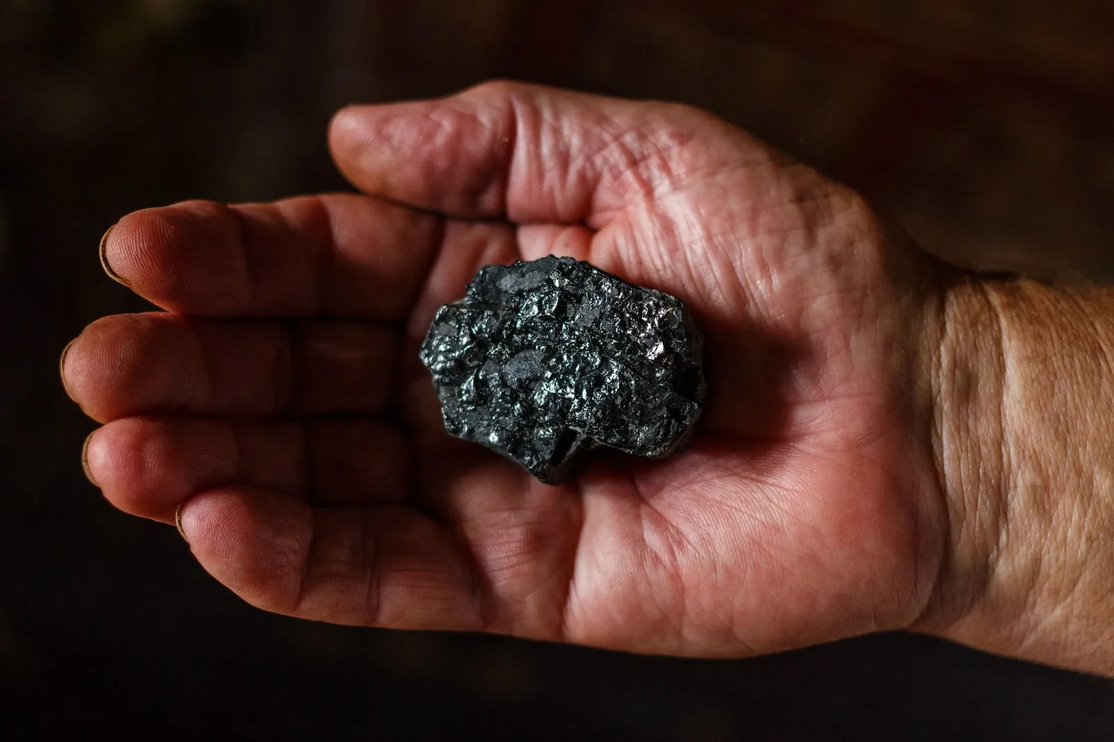 Ore specimen held in a hand